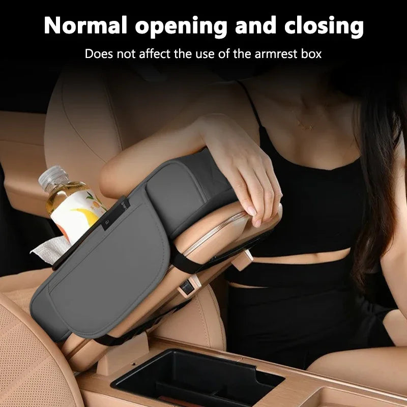 A hand is using a car center console organizer with an armrest cushion and cup holder on a vehicle.