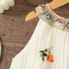 White sleeveless dress for baby girls with floral embroidery on the neckline