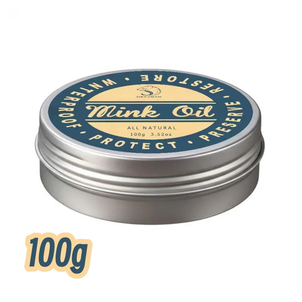 A silver tin of Mink Oil leather conditioner balm with a yellow label and black text.