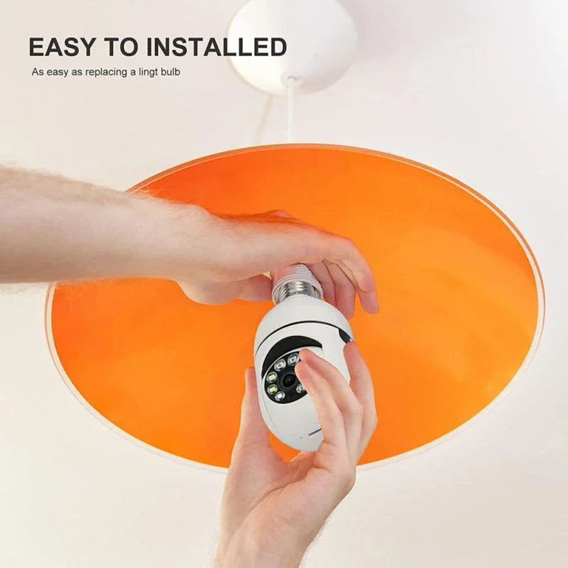 A hand is installing a white smart security camera onto an orange circular light fixture.