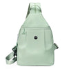 A light mint green lightweight oxford cloth mini backpack with a drawstring closure.