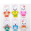 A set of four wooden puzzle dress-up bears for children in various colors and outfits.
