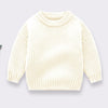 A cream colored knitted long-sleeve pullover sweater for kids.