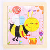 A wooden puzzle featuring a yellow and black bee design on a pink background.