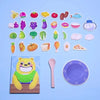 A collection of colorful food shapes and a wooden bear toy for a toddler feeding game