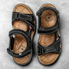 Pair of black leather air cushion sandals with brown straps and sole