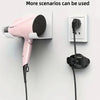 A pink hair dryer is shown with its cord plugged into a wall mount, next to a white electrical outlet.