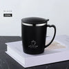 A black 350ml stainless steel insulated travel mug with a handle resting on a white box.