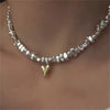 Collar de cadena de cuentas geométricas plateadas con un pequeño colgante de corazón