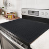 A black silicone stove protector mat is shown resting on a stovetop, with a digital timer display visible.
