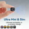 A hand holds a small, black mini security camera against a light blue background.