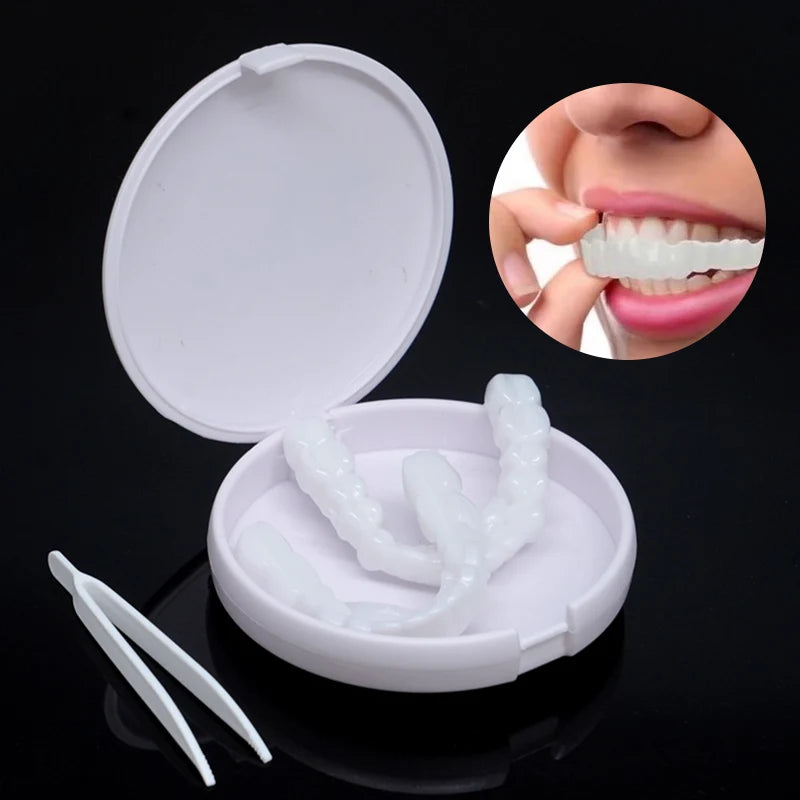 A kit containing cosmetic denture teeth, including a removable tray and individual teeth models for dental practice.