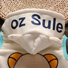 A white fleece pajama set with blue lettering that reads oz Sule, featuring a cartoon animal design.