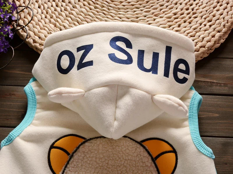 A white fleece pajama set with blue lettering that reads oz Sule, featuring a cartoon animal design.