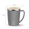 A silver stainless steel insulated travel mug with a light beige lid and handle, shown in a side view.