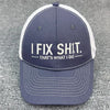 A dark blue baseball cap with white trim featuring embroidered text that reads I FIX SHIT THAT'S WHAT I DO
