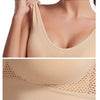 A beige breathable plus size sports bra featuring a V-neckline and mesh detailing.