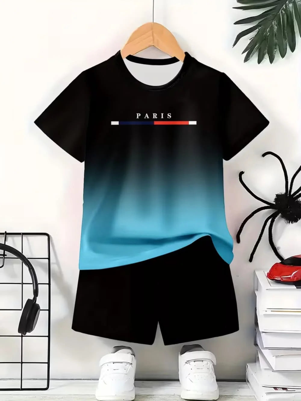 A black t-shirt and matching black shorts set featuring a blue gradient design with the word PARIS.