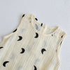 A cream-colored baby cotton sleeveless jumpsuit bodysuit set with small black crescent moon patterns.