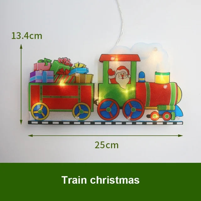 An LED train Christmas decoration featuring Santa Claus and gifts, suspended by a thin wire.