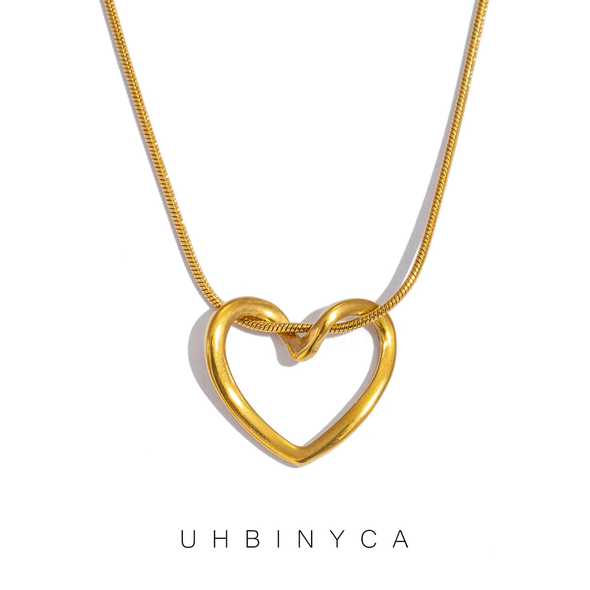 A dainty gold heart pendant necklace featuring a snake chain.