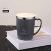 A grey 350ml stainless steel insulated travel mug with a light-colored lid is resting on a white box.
