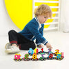 A toddler is playing with a colorful magnetic wooden number train set featuring numbers 1 through 9.