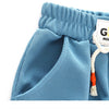 Light blue kids beach shorts with an elastic waist and a white tag