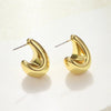 Pair of vintage gold-plated dome drop earrings with a curved, elongated design.