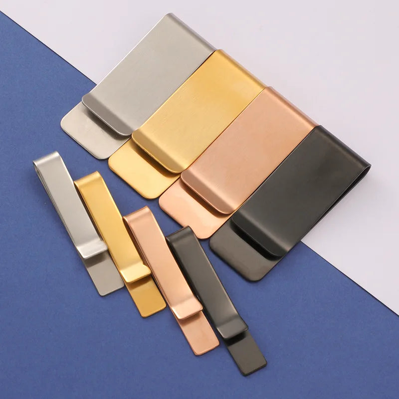 A collection of classic metal tie clips in various shades including silver, gold, rose gold, and bronze, arranged diagonally 