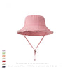 A pink wide-brim bucket hat with a frayed edge and pink ties.