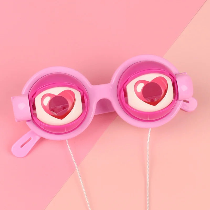 A pair of pink novelty glasses with heart-shaped lenses and a string attached.
