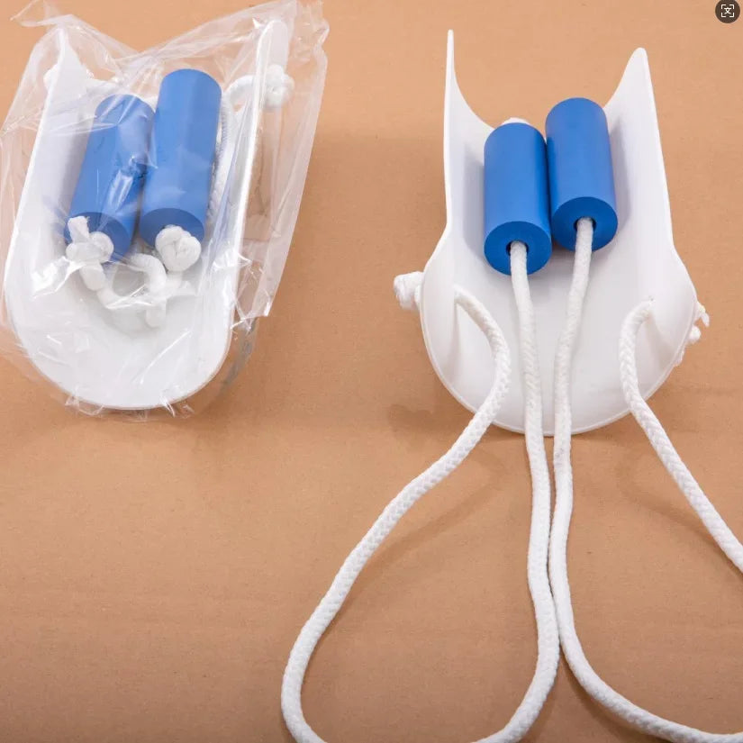 A white plastic container holds two blue sock aids with white loops, shown on a brown surface.