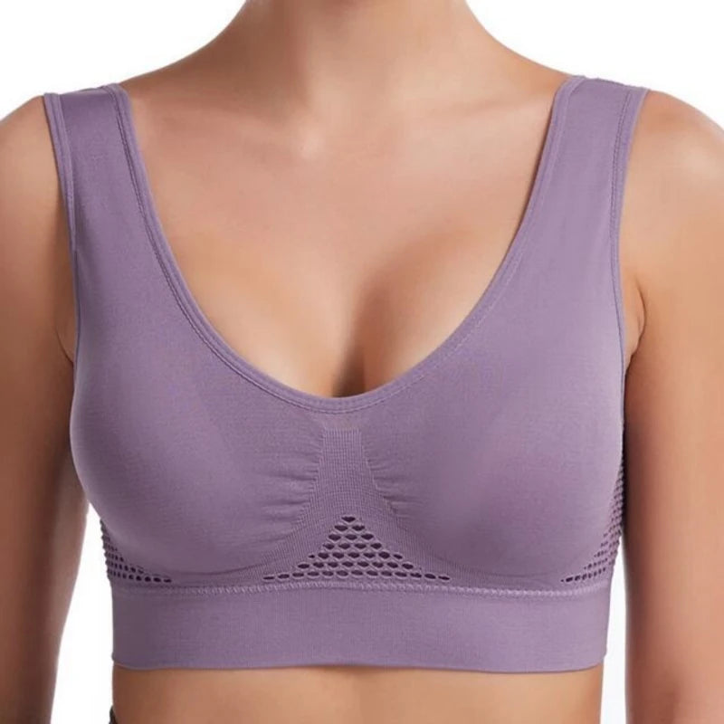 A purple breathable plus size sports bra with padded support shown on a model's chest.