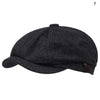 A dark gray knitted newsboy cap or beret shown from above.