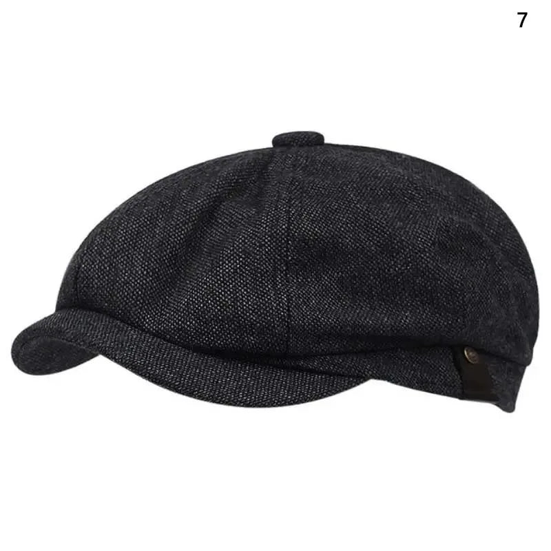 A dark gray knitted newsboy cap or beret shown from above.