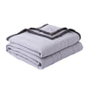 A stack of light gray breathable cooling throw blankets with dark trim.
