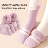 A pair of light purple fleece winter socks with a white stripe pattern worn on a foot.