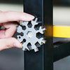 A hand is inserting a multi-tool with various tips into a black metal bar.