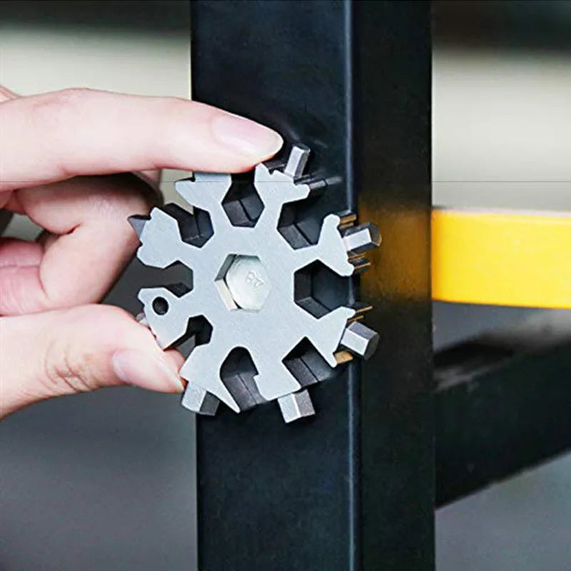 A hand is inserting a multi-tool with various tips into a black metal bar.