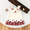 A white kids summer pinafore dress with strawberry and bunny print, featuring red trim and a plaid skirt.