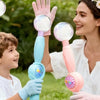 A woman and a boy are playing with a pink smoke bubble wand, showing the device's use.
