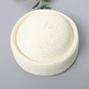 A round straw sun hat with a wide brim in a natural beige color, shown against a gray background.