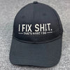 Black embroidered mechanic dad hat with white text that says I FIX SHIT THAT'S WHAT I DO