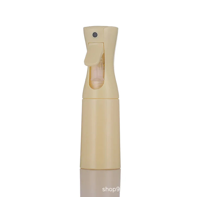 A light beige continuous fine mist spray bottle with a clear liquid reservoir and a yellow cap.