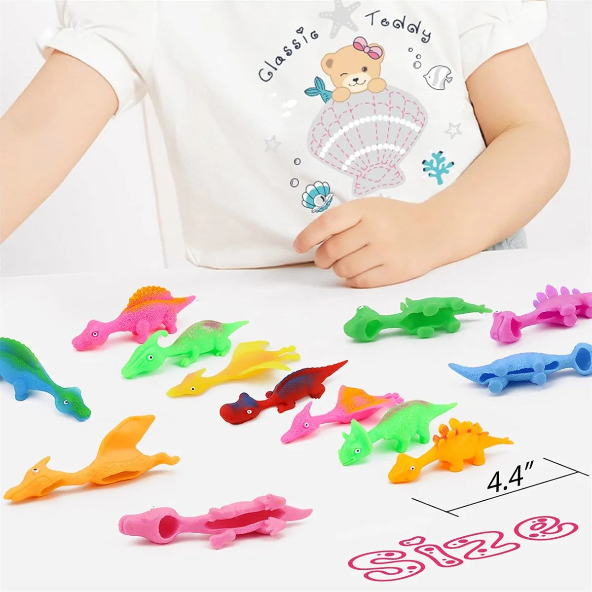 A set of colorful dinosaur finger catapult toys for kids displayed on a white surface.