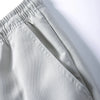 Light gray men's cargo joggers showing the waistband and fabric texture.