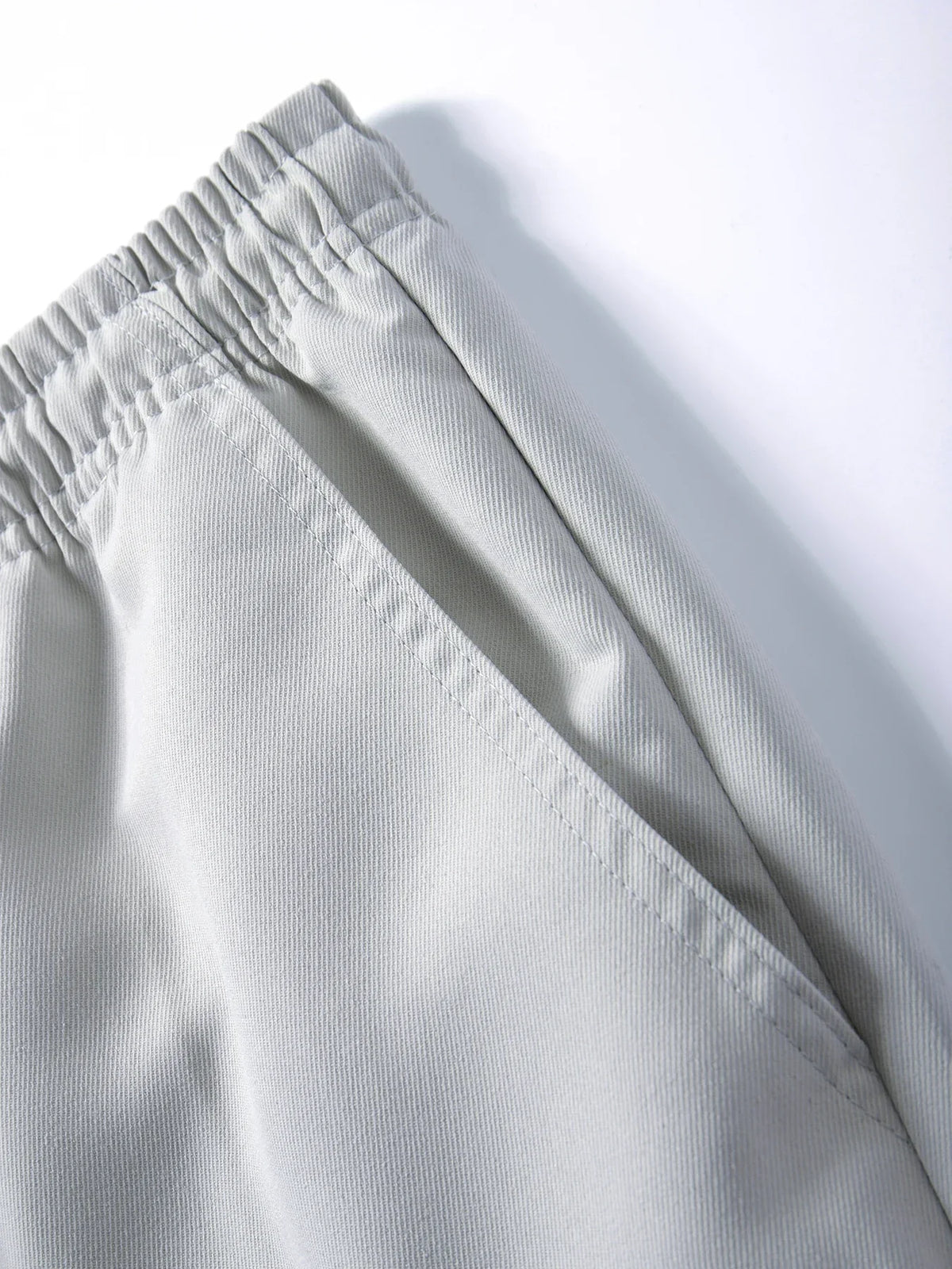 Light gray men's cargo joggers showing the waistband and fabric texture.