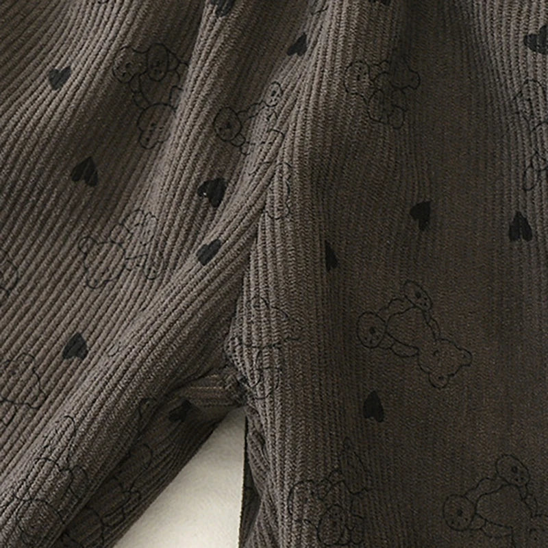Close-up of dark gray fleece-lined pants with a subtle pattern of small hearts.