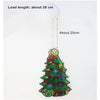 A green Christmas tree decoration with gifts and ornaments hangs from a white light source.